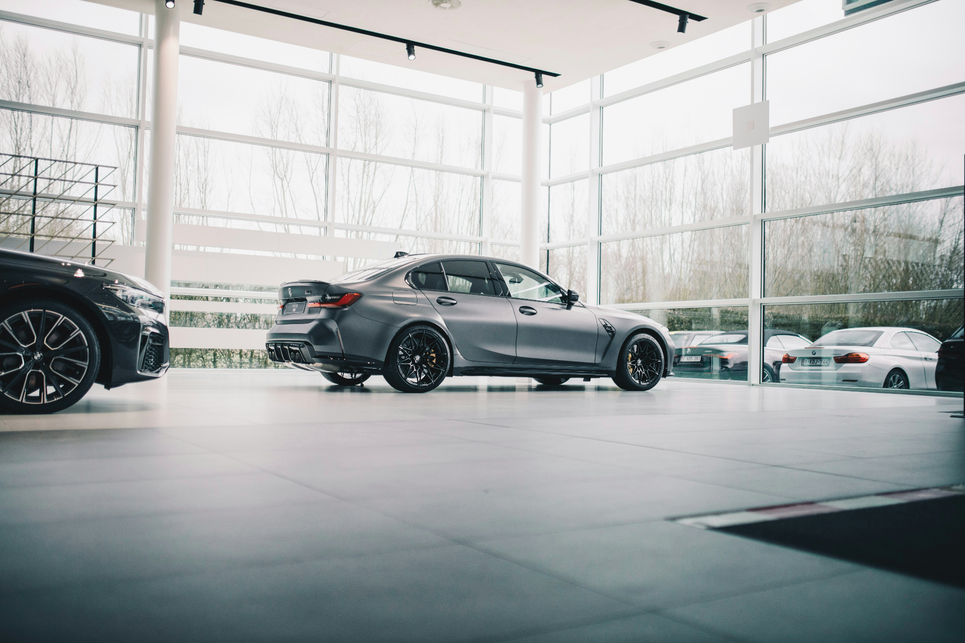Pristine car dealership showroom with floor-to-ceiling glass